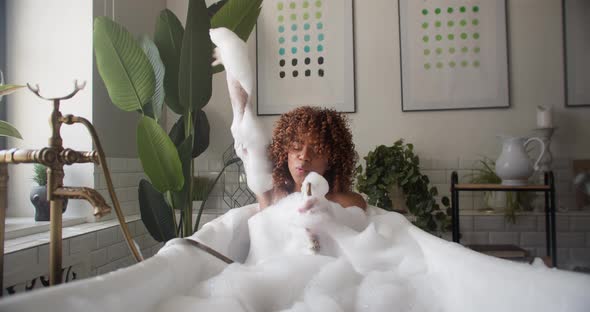 Girl in Foam From Head to Toe in the Bath Fooling Around