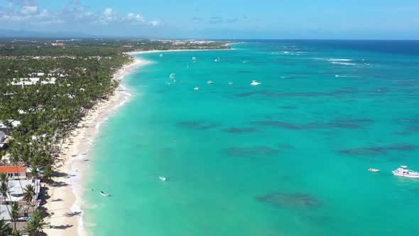 Tropical Seashore with Resorts Palm Trees and Caribbean Sea with Floating Boats and People Having