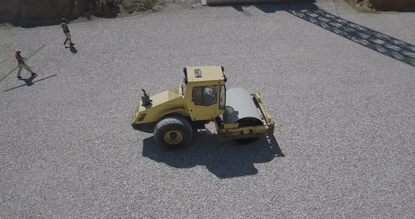 Filmed From Above How a Yellow Singlecylinder Asphalt Roller Works Straightens the Stone on the