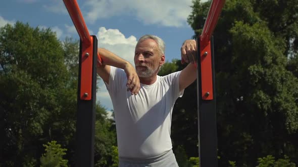 Attractive Handsome Strong Men Standing Near Bars Rest After Training, Slow-Mo