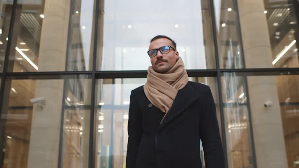 Handsome Stylish Businessman Walking Out of Business Center