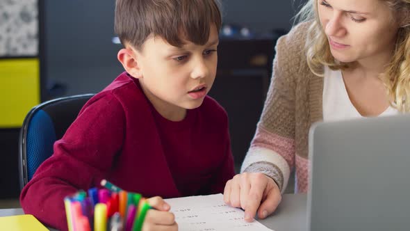 Handheld video of son doing math homework with mom. Shot with RED helium camera in 8K