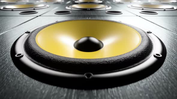 Moving over Audio Speakers with Yellow Membranes Playing Rhythmic Music