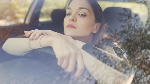 Sad Young Woman in a Car