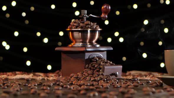 Coffee Grinder with Grains and Cup Hot Drink with Smoke