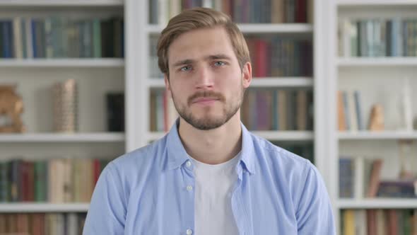 Portrait of Man Shaking Head As No Sign Denial