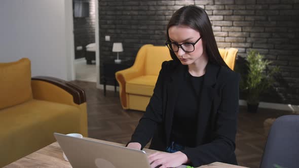 Young Businesswoman in Glasses Typing on Laptop Working in Internet Beautiful Woman Doing Online Job