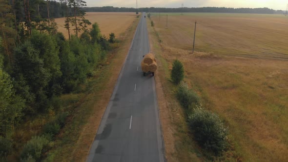 Overloaded Tractor Trailer Carrying Bales of Straw for Animal Bedding in the Countryside