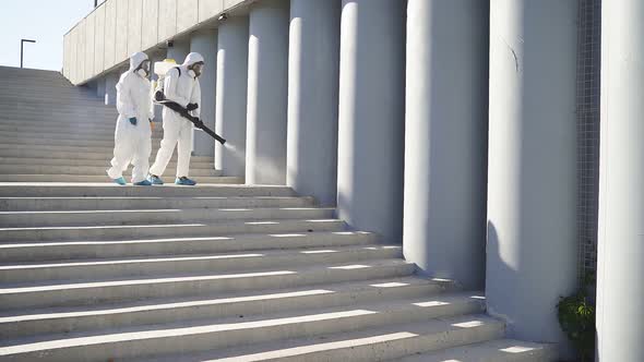 Two Workers of Disinfection Service Work As One Team