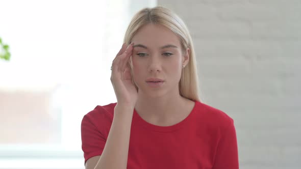 Portrait of Young Blonde Woman with Emotional Stress having Headache