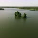 Top view of the lake, small island and the fisherman on the boat, 4k drone. - VideoHive Item for Sale