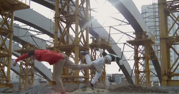 Two Boys Parkouring at Construction Site