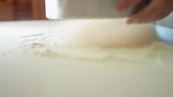 Female Hands Sift White Wheat Flour Through a Sieve