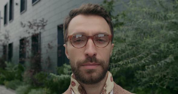 Portrait of Serious Bearded Man with Neckerchief Looking Aside and Than To Camera