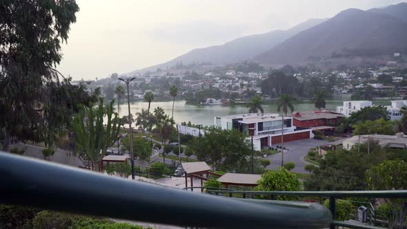 Stabilized sliding shot from left to right looking over the town in Las Lagunas, La Molina, Lima, Pe