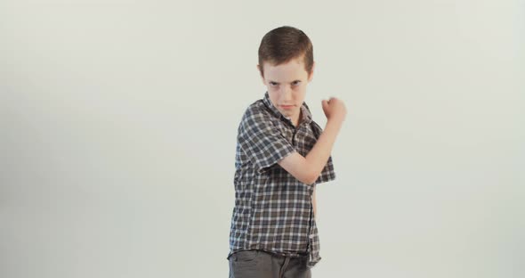 Young boy acting angry and mad on a white studio background