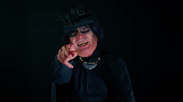 Creepy Man Grandfather with Halloween Stylish Witcher Makeup Pointing Finger to Camera Laughing