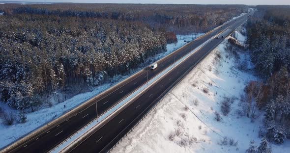Aerial View of a Highway Road with Traffic Cars and Trucks on the Road in Winter