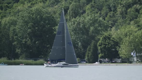 A sailboat moving closer the main harbor on the Balaton lake, Tihany.