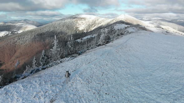 Drone Flying Over Man Hiker Walking on a Summit Ridge