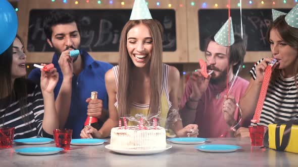 Woman Blows Birthday Candles