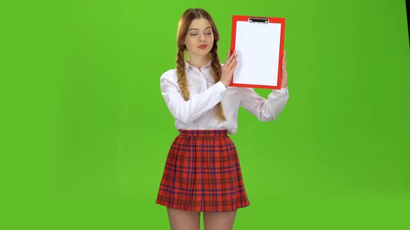 Student Raises a Red Tablet with Paper. Green Screen