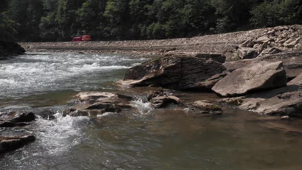 Shallow Mountain River Flowing Near Road