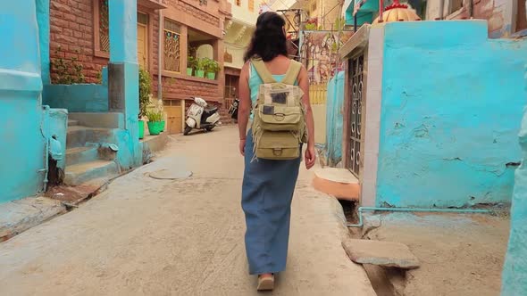 Female Tourist Walks Through the Streets of an Indian City