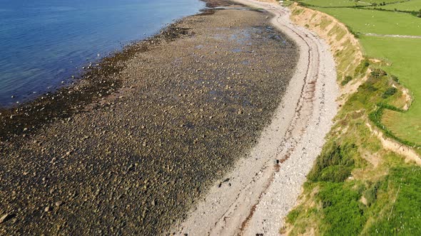 Rocky Beach Coast of Llyn Peninsula in Wales - Aerial Drone Tilt Up Reveal