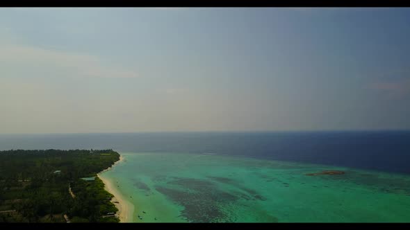 Aerial above travel of tranquil lagoon beach lifestyle by blue water with bright sandy background of