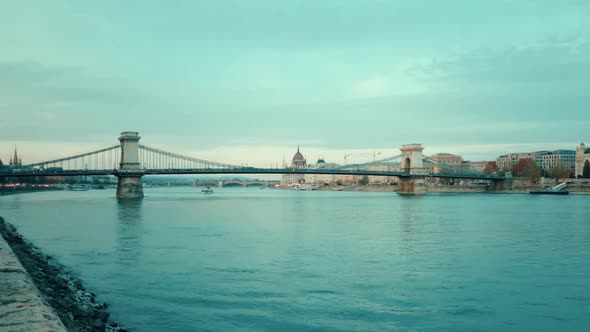 A still image of the Chain Bridge and its traffic near the shore.