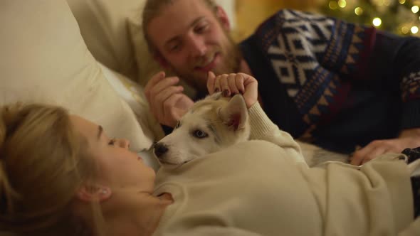 Joy and Merriment of Glad Couple Having Fun During Family Christmas Evening at Their Cozy Home