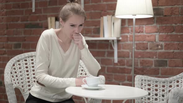 Attractive Young Woman Drinking Coffee and Coughing