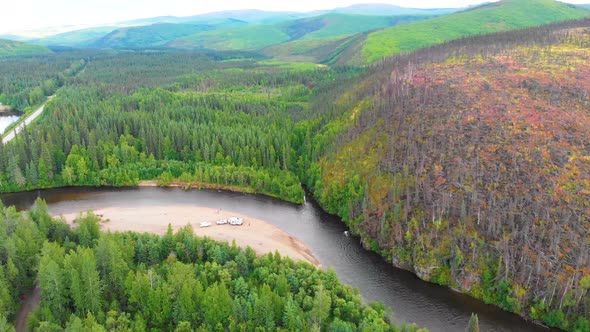 4K Drone Video of Campsite on Rock Beach of Chena River below Fire Damaged Montains near Chena Hot S