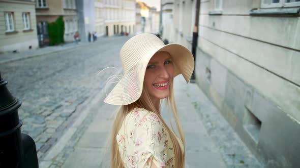 Woman Gesturing Follow Me on Street. Smiling Young Girl Looking at Camera and Gesturing Follow Me on