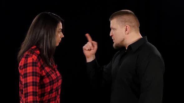 Angry Man Shouting and Shaking Woman. Black. Close Up