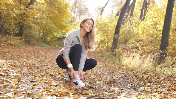 Happy Blonde Sportswear Pleased Herself Stopped While Jogging To Tie Her Shoelaces Jogging Autumn