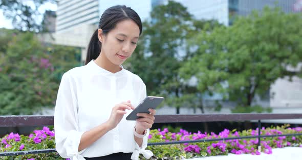 Woman use of mobile phone in city