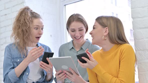 Happy Young Women Using Smartphone and Tablet