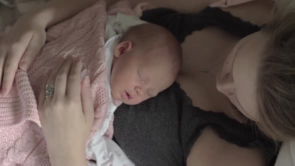 Newborn Baby Sleeping on Mothers Chest