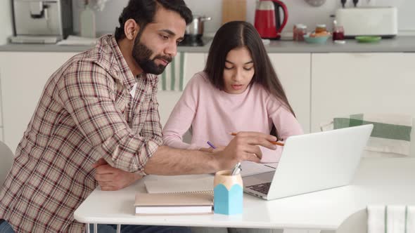 Young Indian Father and Daughter e Learning Together Using Laptop at Home