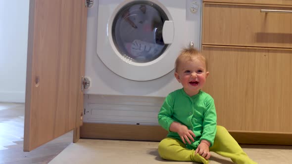 Child is Looking Into the Washing Machine