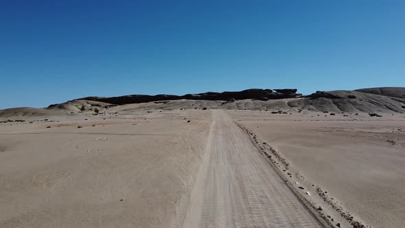 Stunning aerial view on the huge mountains in a desert of Namibia, blue sky