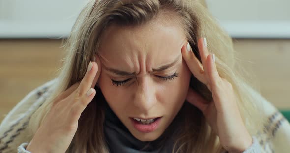 Close Up of Frustrated Stressed Young Woman Coping with Headache Migraine