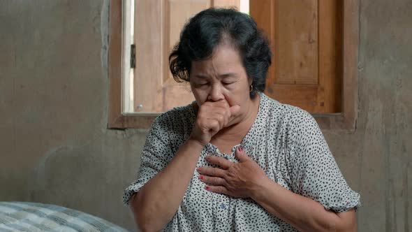 Sick Asian Senior Woman Having Cough In Country Home