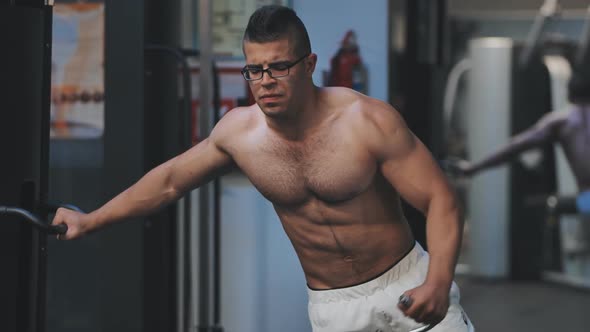 Arab Man Doing Shoulder Exercise in the Gym