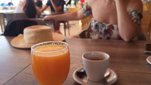 Glass of Orange Juice and Coffee in Cafe