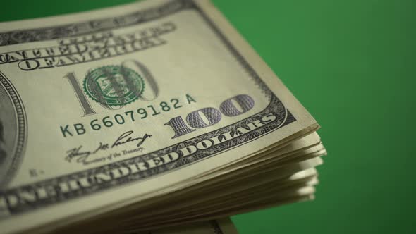 Counting 100 Dollars Isolated On Chroma Key Green Screen Background