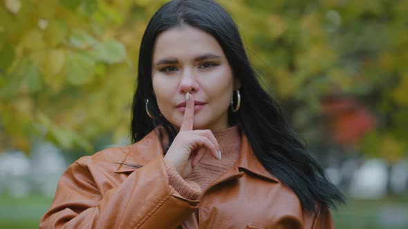 Portrait Hispanic Woman Stands Outdoors Serious Girl Looking at Camera Holds Index Finger Near Mouth