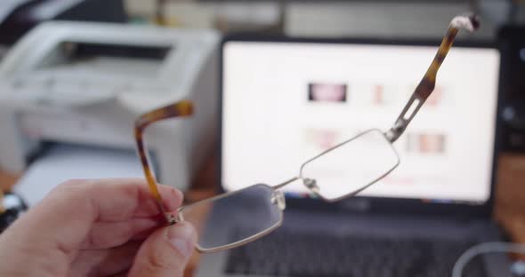 View From the Eyes  a Man Wipes His Glasses